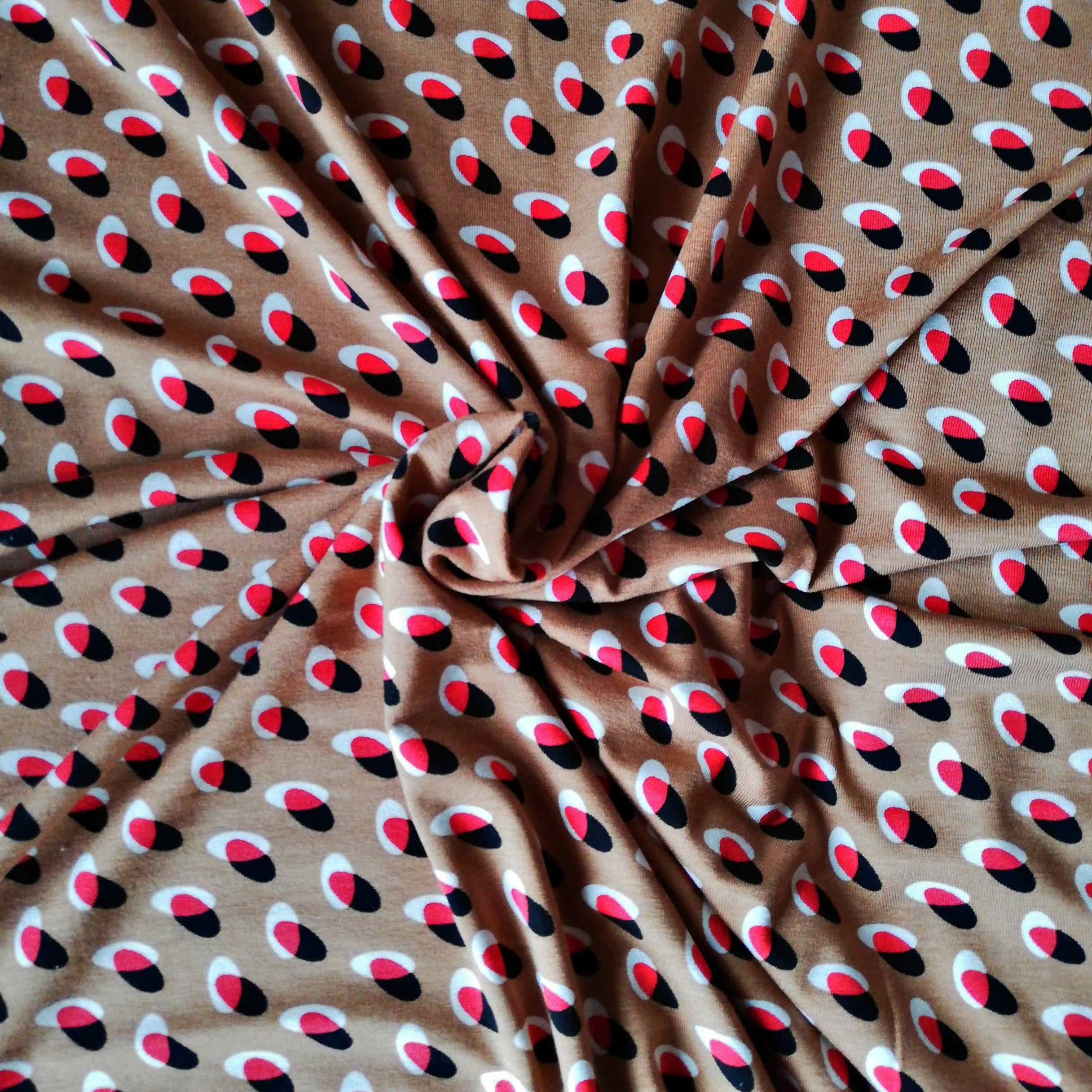 Nougat-colored viscose jersey with red, white and black overlapping circles