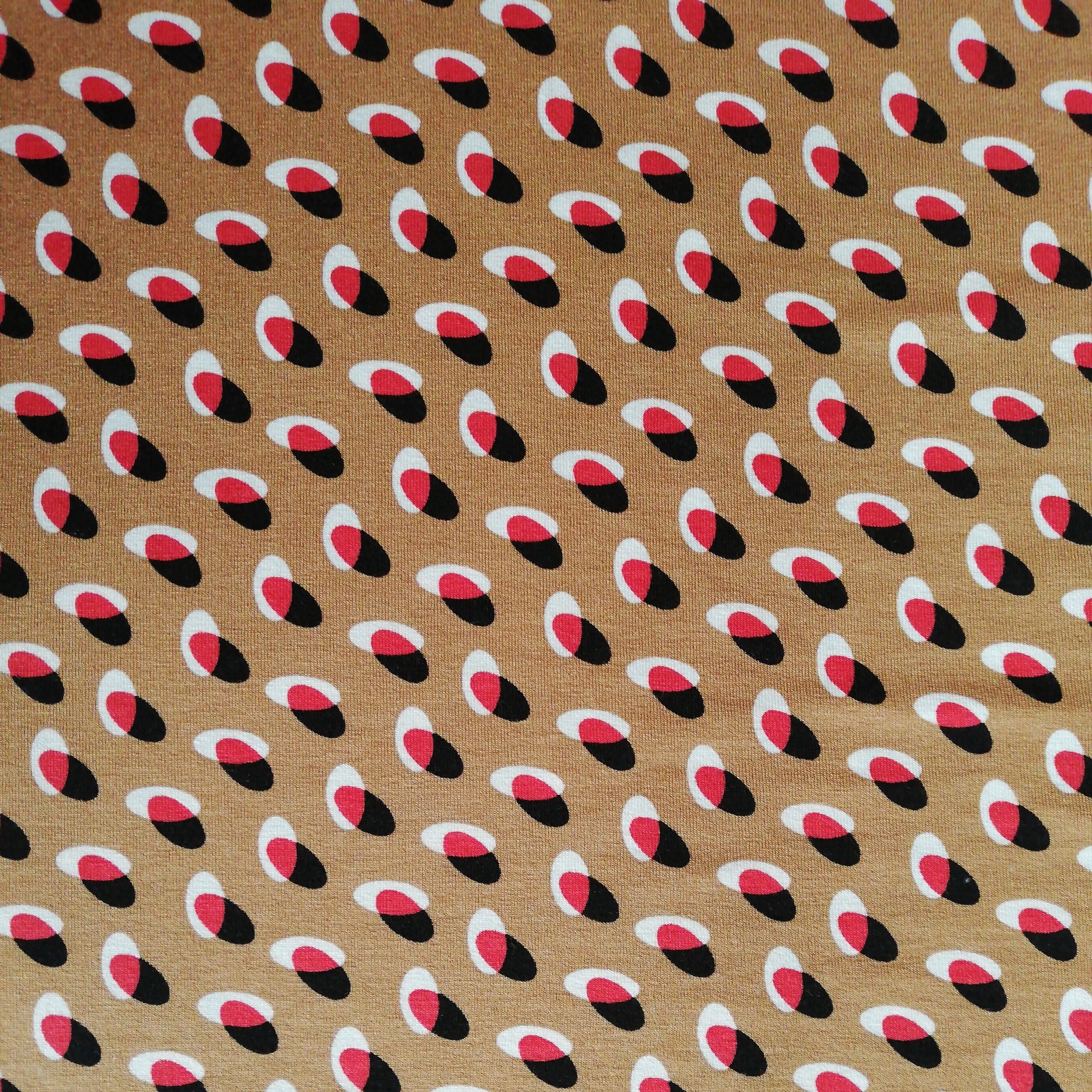 Nougat-colored viscose jersey with red, white and black overlapping circles