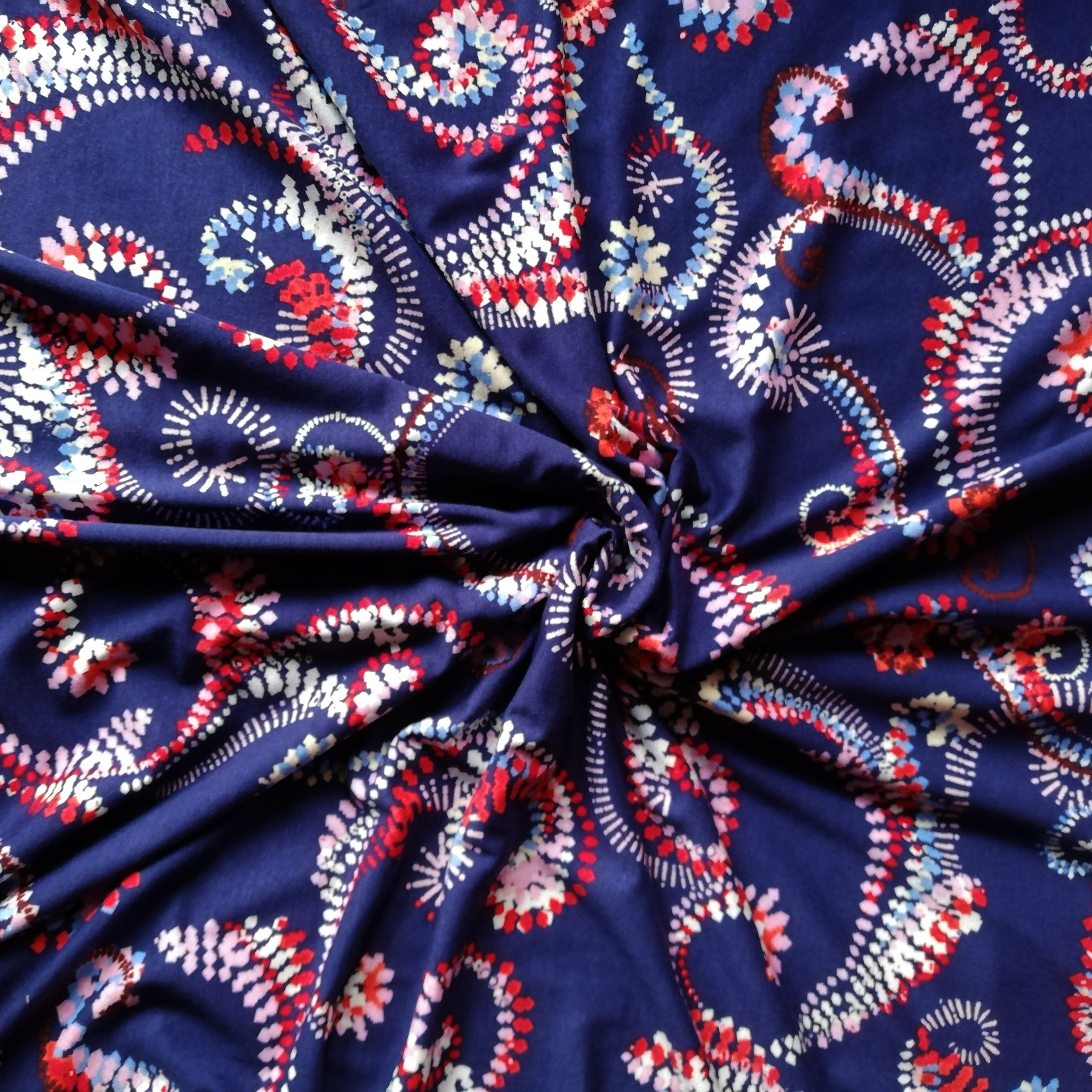 Blue viscose jersey with red and white ornaments 